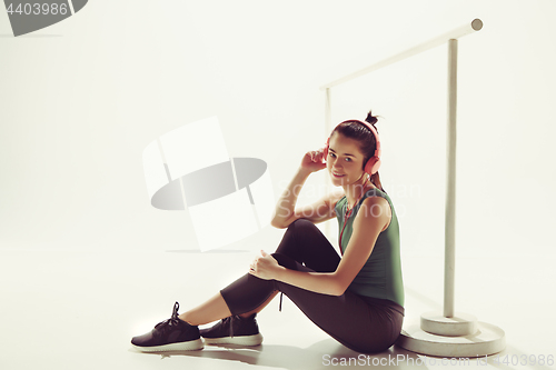 Image of Front view of a young woman sitting with headphones