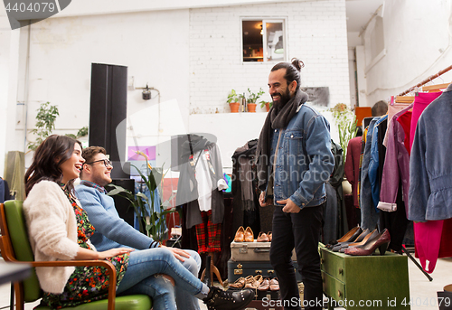 Image of friends choosing clothes at vintage clothing store