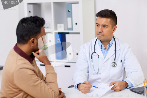 Image of doctor showing prescription to patient at clinic