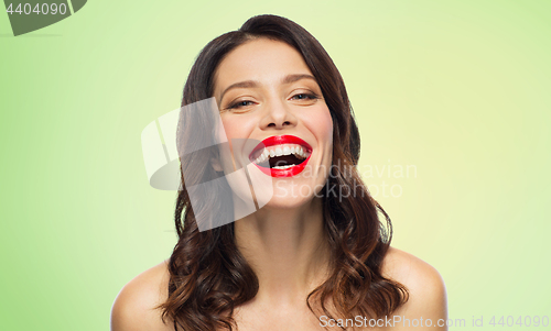 Image of beautiful laughing young woman with red lipstick