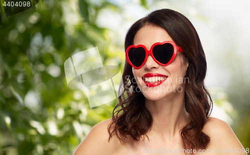 Image of woman with red lipstick and heart shaped shades