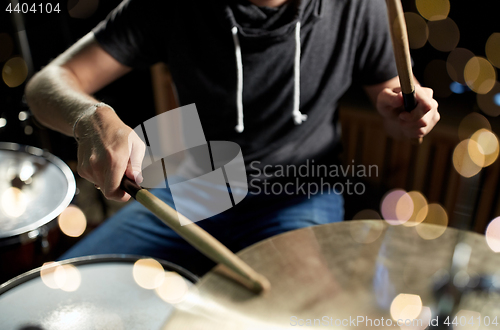 Image of male musician playing drum kit at concert