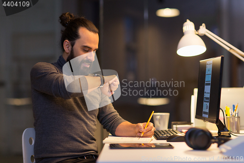 Image of man with smartwatch using voice recorder at office