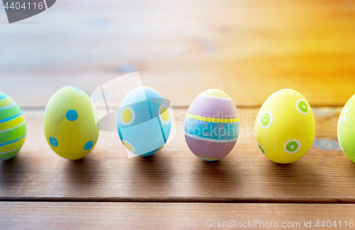 Image of colored easter eggs on wooden surface