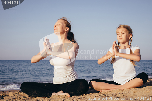 Image of Happy family standing on the beach at the day time.