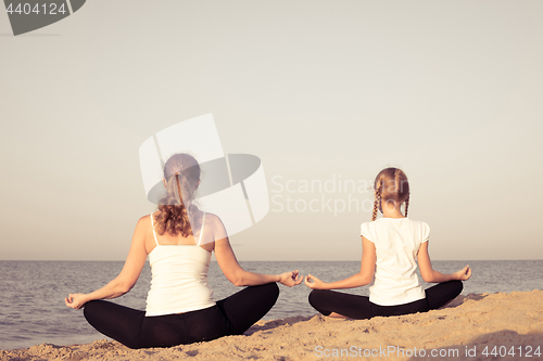 Image of Happy family standing on the beach at the day time.