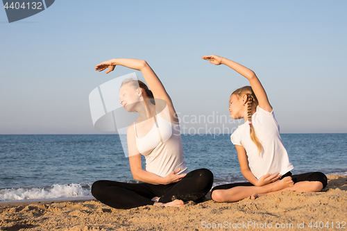 Image of Happy family standing on the beach at the day time.