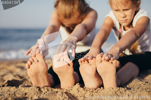 Image of Happy family standing on the beach at the day time.