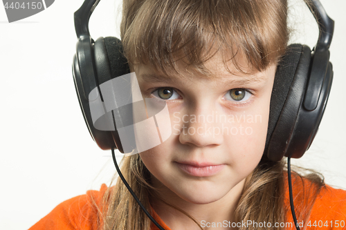 Image of Portrait of a purposeful girl with headphones