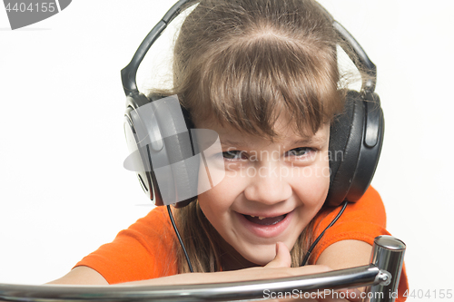 Image of Portrait of a cheerful girl with headphones