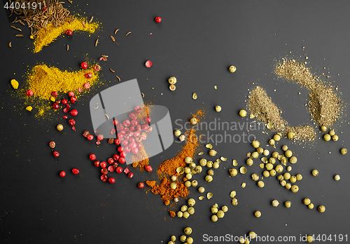 Image of various spices on black background