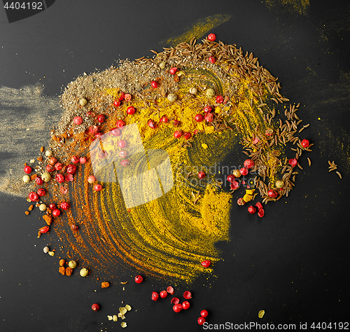 Image of various spices on black background