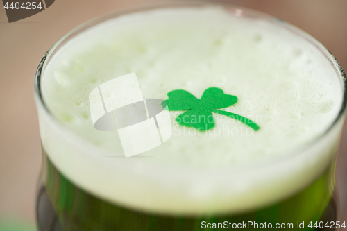 Image of close up of glass of green beer with shamrock