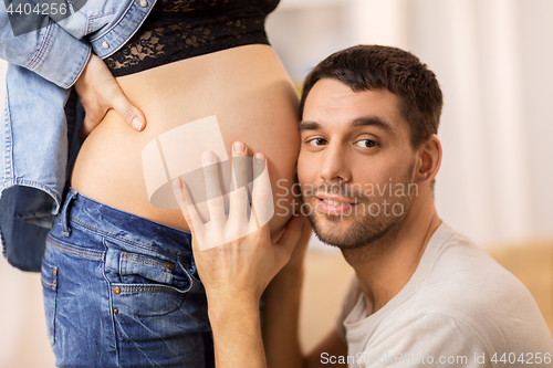 Image of happy man touching pregnant woman belly