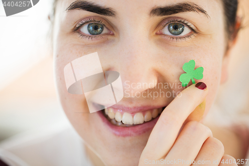 Image of close up of happy young woman face with shamrock