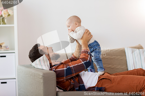 Image of happy father with little baby boy at home