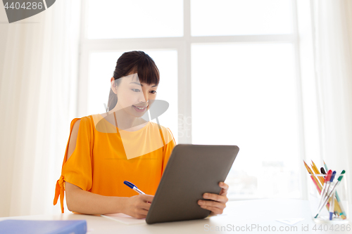 Image of asian student girl with tablet pc learning at home