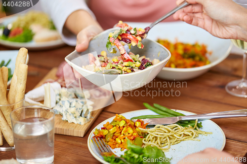 Image of people eating salad at table with food