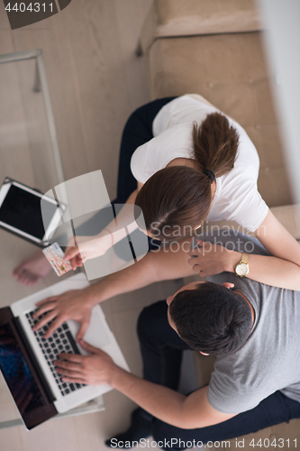 Image of happy young couple buying online