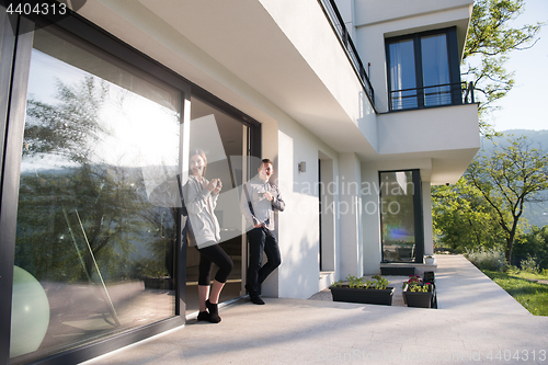 Image of couple enjoying on the door of their luxury home villa