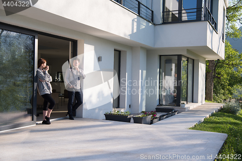 Image of couple enjoying on the door of their luxury home villa