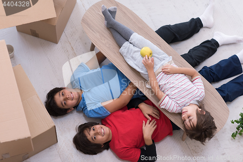 Image of boys with cardboard boxes around them top view