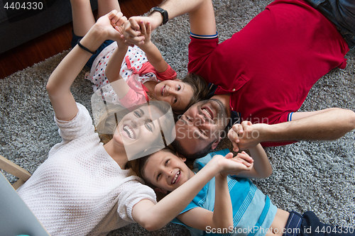 Image of happy family lying on the floor