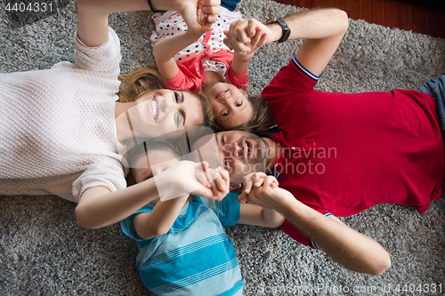 Image of happy family lying on the floor