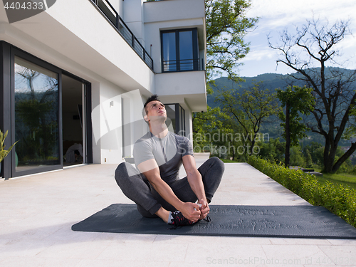 Image of man doing morning yoga exercises