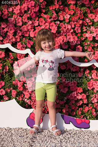 Image of little cute girl in a flower garden