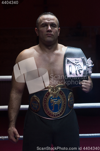 Image of kick boxer with his championship belt