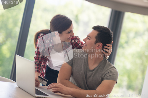 Image of happy young couple buying online