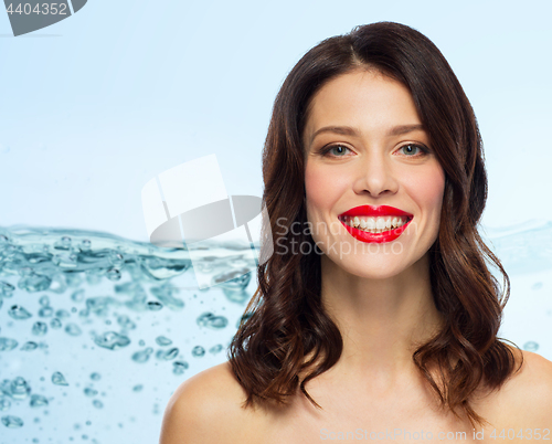 Image of beautiful smiling young woman with red lipstick