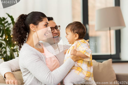 Image of happy family with baby daughter at home