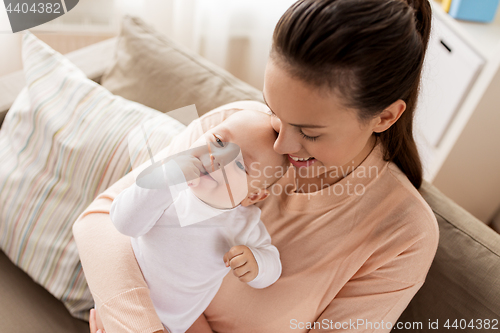 Image of happy mother with little baby boy at home