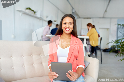 Image of happy asian woman with tablet pc working at office