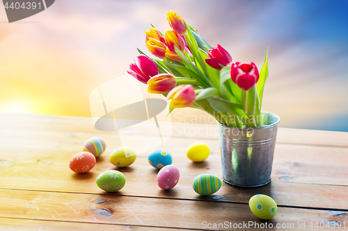 Image of close up of easter eggs and flowers in bucket