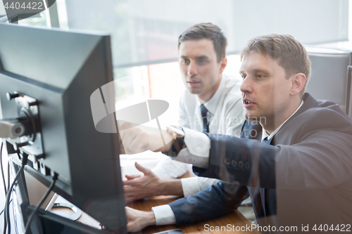 Image of Business team analyzing data at business meeting.