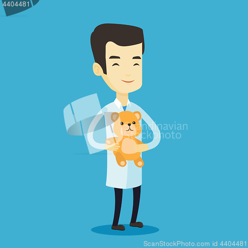 Image of Pediatrician doctor holding teddy bear.