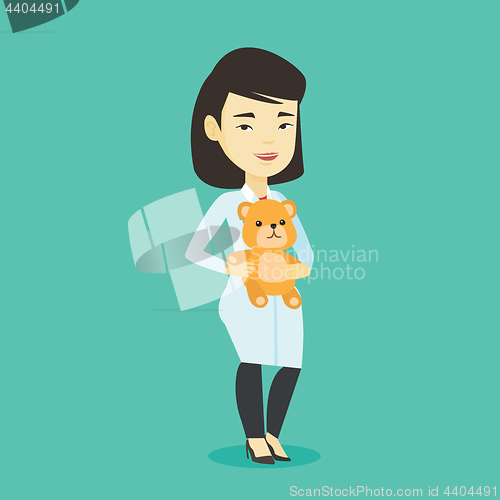 Image of Pediatrician doctor holding teddy bear.