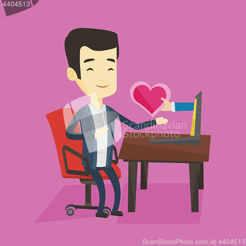 Image of Young man dating online using laptop.