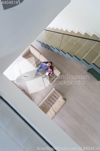 Image of mother and her cute little daughter are using a tablet top view