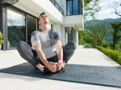 Image of man doing morning yoga exercises