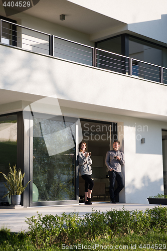 Image of couple enjoying on the door of their luxury home villa