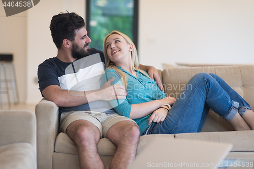 Image of young happy couple relaxes in the living room