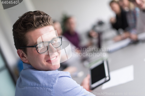 Image of Businessman using tablet in modern office