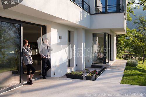 Image of couple enjoying on the door of their luxury home villa