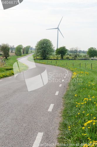 Image of Wind turbine by a winding country road