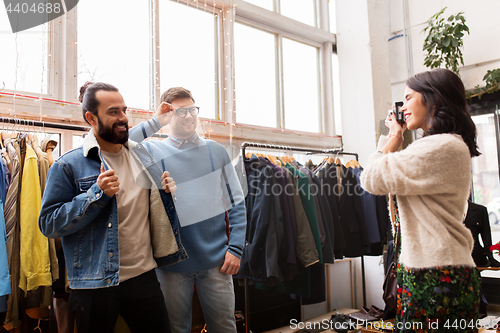 Image of friends photographing at vintage clothing store