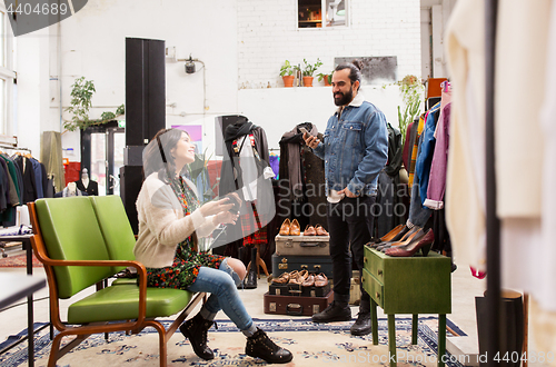 Image of couple choosing footwear at vintage clothing store